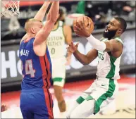  ?? Jose Juarez / Associated Press ?? Boston Celtics guard Jaylen Brown, right, drives against Detroit Pistons center Mason Plumlee during the first half Sunday in Detroit. Brown led the Celtics with 31 points