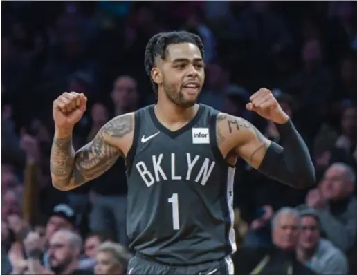  ?? HOWARD SIMMONS — THE ASSOCIATED PRESS ?? Brooklyn Nets guard D’Angelo Russell (1) reacts to a teammate scoring during a recent game against the Sacramento Kings in New York.