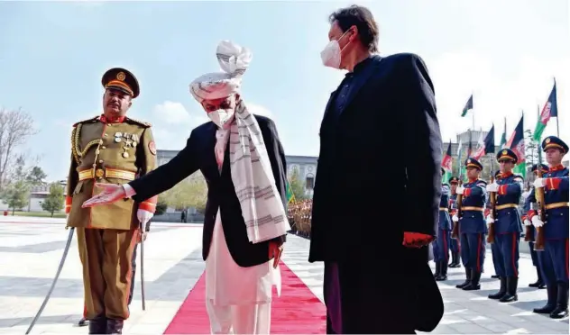 ?? Agence France-presse ?? President Ashraf Ghani (centre) gestures to Imran Khan during a guard of honour ahead of their joint press conference at the Presidenti­al Palace in Kabul on Thursday.