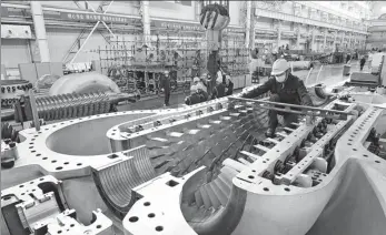  ?? SHAO RUI / XINHUA ?? Shaanxi Blower Group Co employees work on a production line in Xi’an, Shaanxi province, on Nov 18.