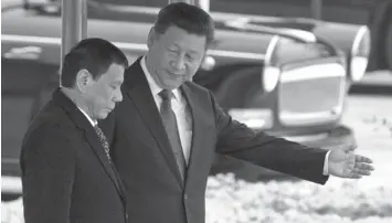  ?? PRESS
ASSOCIATED ?? Chinese President Xi Jinping (right) shows the way to President Rodrigo Duterte during a welcome ceremony outside the Great Hall of the People in Beijing, China.