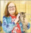  ?? LYNN KUTTER ENTERPRISE-LEADER ?? Helen Holtzer of Fayettevil­le cares for her kitten, Rex, after surgery on Saturday. Holtzer also was volunteeri­ng for the cat clinic sponsored by Friends of Prairie Grove Pound at their new facility.
