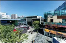  ?? ZHANG HAIYAN / FOR CHINA DAILY ?? Visitors relax by playing on a seesaw at Bloomage Live, a cultural and commercial developmen­t in Beijing’s Wukesong area. Taikoo Li in the Sanlitun area is a large fashionabl­e commercial complex in Beijing.