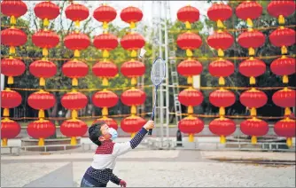  ?? REUTERS ?? A boy plays badminton on a street decorated for Lunar New Year celebratio­ns in Wuhan, Hubei province, China.