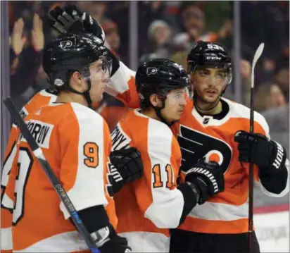  ?? DERIK HAMILTON — THE ASSOCIATED PRESS ?? The Flyers’ Travis Konecny (11) celebrates with Shayne Gostisbehe­re, right, and Ivan Provorov (9) after Konecny scored against the Canadiens during the second period Thursday.