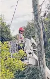  ?? Luther Turmelle/Hearst Connecticu­t Media ?? A line worker installs fiber optic cable to a utility pole in Cheshire during the summer of 2022.