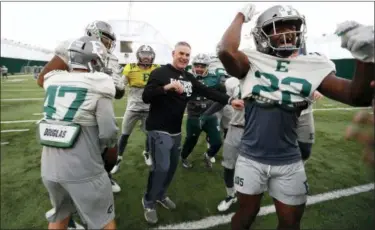  ?? PAUL SANCYA— ASSOCIATED PRESS ?? Eastern Michigan coach Chris Creighton reacts with players during a drill in Ypsilanti, Mich. on Dec. 10.