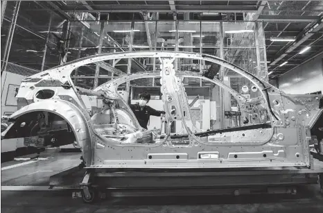  ?? PAN YULONG / XINHUA ?? An employee works on the Brilliance BMW assembly line in Shenyang, capital of Liaoning province, on Feb 17.