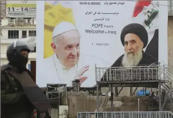  ??  ?? A poster of Pope Francis and Grand Ayatollah Sayed Ali al-Sistani is seen along a street ahead of the Pope’s planned visit to Iraq, in central Baghdad on March 4, 2021 | AFP