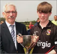  ??  ?? Kyle Rankin is presented with the trophy by Ian Lawlor.