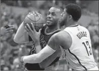  ?? AP/DARRON CUMMINGS ?? Cleveland forward LeBron James (left) has been a part of 21 consecutiv­e victories in the first round of the NBA Eastern Conference playoffs after his 33 points helped the Cavaliers beat Indiana 106-102 on Sunday to complete a four-game sweep.