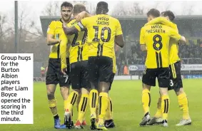  ??  ?? Group hugs for the Burton Albion players after Liam Boyce opened the scoring in the third minute.