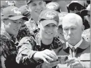  ?? AP/EUGENE HOSHIKO ?? Vice President Mike Pence poses for a selfie with a U.S. serviceman aboard the USS Ronald Reagan during a visit to the nuclear-powered aircraft carrier docked at the Navy’s base in Yokosuka, Japan.