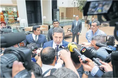  ??  ?? Boca Juniors president Daniel Angelici talks with reporters after a meeting with his River Plate counterpar­t and the Conmebol chief in Luque, Paraguay.