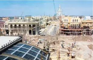  ?? ORLANDO SENTINEL FILE ?? Looking toward Cinderella Castle, the Magic Kingdom’s Main Street U.S.A. starts to take shape as workers scramble to get the theme park completed in time for its scheduled opening on Oct. 1, 1971.