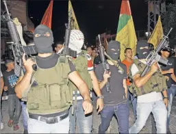  ??  ?? Free rein: The Al Aqsa Martyrs Brigade, which is on the US terrorist list, is allowed to parade openly with weapons — with no objections from Abbas.