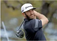  ?? — AP ?? Dustin Johnson watches his shot from the first tee during roundrobin play against Webb Simpson.