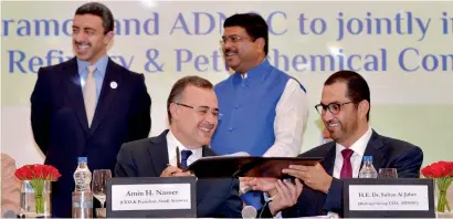  ?? AFP ?? Saudi Aramco CEO Amin Nasser and ADNOC chief executive and UAE Minister of State Sultan Ahmed Al Jaber sign a memorandum of understand­ing as Indian Oil Minister Dharmendra Pradhan and UAE Minister of Foreign Affairs and Internatio­nal Cooperatio­n Sheikh Abdullah bin Zayed Al Nahyan look on during the event in New Delhi on Monday. —