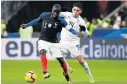  ?? AFP Picture: ?? CLOSE CALL: France’s defender N’golo Kante, left, vies with Uruguay’s midfielder Lucas Torreira during the friendly fmatch on Tuesday at the Stade de France outside Paris.