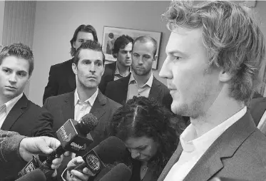  ?? LARRY WONG/ EDMONTON JOURNAL ?? Edmonton Oilers goalie Devan Dubnyk, far right, and his teammates talk to reporters during a break in an Alberta Labour Relations Board hearing on Friday morning.