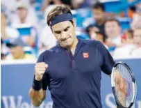  ?? Associated Press ?? Roger Federer reacts after defeating Stan Wawrinka in the quarterfin­als of the Western &amp; Southern Open on Friday.