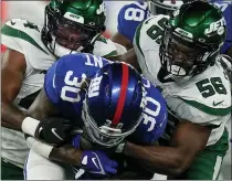  ?? FRANK FRANKLIN II - THE ASSOCIATED PRESS ?? New York Giants running back Corey Clement (30) is tackled by New York Jets linebacker Noah Dawkins (56) and linebacker Jamien Sherwood, left, in the first half of an NFL preseason football game, Saturday, Aug. 14, 2021, in East Rutherford, N.J.