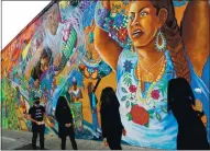  ?? ARIC CRABB — STAFF PHOTOGRAPH­ER ?? Three mourners and an ambassador walk through Berkeley on their way to the Fruitvale BART station in Oakland on July 23 in a procession intended to collect reparation­s for Black and Indigenous people. Forty daily procession­s are planned.