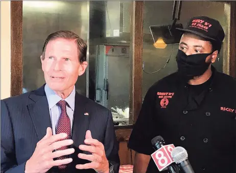  ?? Luther Turmelle / Hearst Connecticu­t Media ?? U.S. Sen. Richard Blumenthal, D-Conn., and Ricky Evans, the owner of Ricky D’s Rib Shack in New Haven, talk with reporters Wednesday about the federal Payroll Protection Program. Blumenthal visited Evans’ restaurant in an effort to urge that the $130 billion that remains in the program be focused on small and minority owned businesses.