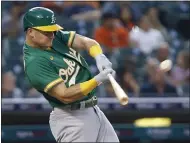  ??  ?? The A’s Matt Chapman hits a two-run home run against the Tigers during the third inning Tuesday in Detroit.