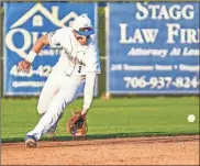  ?? Courtney Couey, Ringgold Tiger Shots ?? Ringgold’s Colin Mountjoy tries to scoop up a grounder during a game this past week. The Tigers ended the week with a shutout of 2019 Class 6A champion Heritage-conyers.