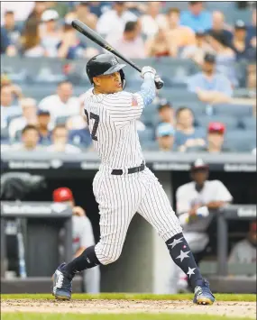  ?? Jim McIsaac / Getty Images ?? Giancarlo Stanton follows through on a third inning three-run home run against Atlanta on Wednesday.