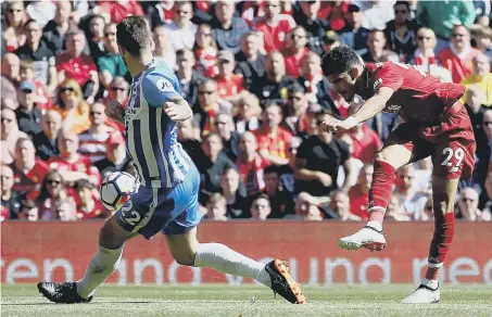  ??  ?? Dominic Solanke hits home his first Liverpool goal to make it 3-0 against Brighton at Anfield yesterday.