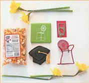  ?? WISCOBOXES ?? WiscoBoxes’ “The Graduate” gift box includes Bucky Badger popcorn, a coaster, a bottle opener, a cap cookie and a handmade miniature replica of Madison’s well-known terrace chairs. All items are made by small producers in Wisconsin.