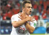  ?? Clive Rose / Getty Images ?? Xherdan Shaqiri of Switzerlan­d celebrates with a hand gesture that references the Albanian national flag after scoring vs. Serbia. Shaqiri was born in Kosovo.