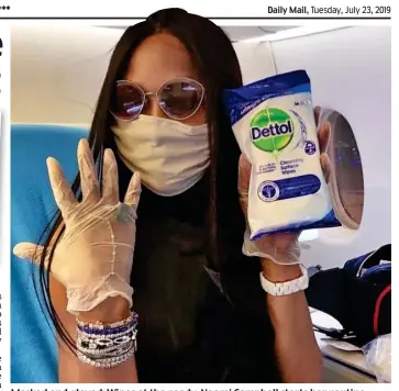  ??  ?? Masked and gloved: Wipes at the ready, Naomi Campbell starts her routine