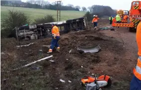  ?? ?? WRECKAGE: The HGV on its side after being forced off the M1. The injured lorry driver had to be cut out of his cab by the fire and rescue service