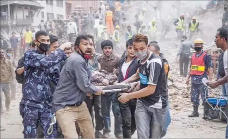  ?? Omar Havana
Getty Images ?? RESCUERS remove a victim after the 1832 Dharahara Tower collapsed in Old Katmandu. Officials said at least 60 tourists were buried.