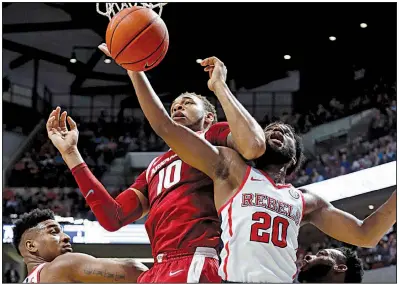  ?? AP/ROGELIO V. SOLIS ?? Ole Miss guard D.C. Davis (20) gets his arm in front of Arkansas forward Daniel Gafford (10) to haul in a rebound during the second half Saturday in Oxford, Miss. The Rebels won 84-67. More photos from this game are available at arkansason­line.com/galleries.