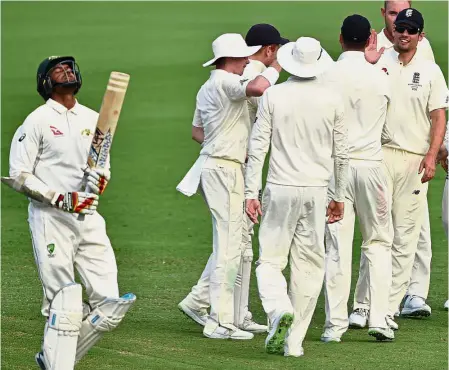  ??  ?? Good job: England players celebratin­g the wicket of Cricket Australia XI batsman Gurinder Sandhu (left) on the first day of the four-day Ashes tour match in Townsville, Australia, yesterday. — AFP