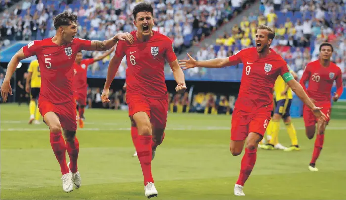 ?? AP ?? Harry Maguire, second from left, put England in the lead against Sweden with his first internatio­nal goal. He became the first defender to score for England at the quarter-final stage of a World Cup