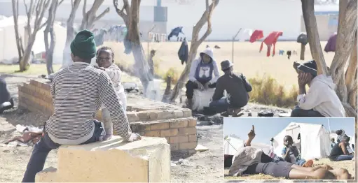  ?? Pictures: Tracy Lee Stark ?? OUT IN THE COLD. Residents from the Cape York building that was gutted by a fire three weeks ago and those evicted from Fattis Mansions last week are pictured at tented accommodat­ion in Turffontei­n yesterday.