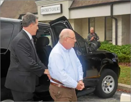  ?? MEDIANEWS GROUP FILE PHOTO ?? In this file photo, former Radnor Board of Commission­ers President Phil Ahr arrives at district court in handcuffs to face child porn charges.