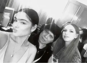  ??  ?? Glamorous life: Latiff (centre) posing for a photo with models Fifi Anicah (left) and Alexandra Goldenberg at the London Fashion Week after-party.