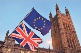  ??  ?? Pro-EU flags fly outside Parliament in London on Dec. 11. A poll in October found that almost half of Britons disapprove of leaving the EU. AFP/GETTY IMAGES