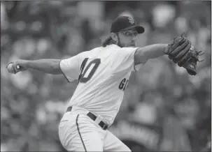  ?? The Associated Press ?? FROM THE LEFT: Madison Bumgarner pitches the San Francisco Giants to a 3-1 victory over the visiting Chicago Cubs on Wednesday, his second win since returning from a dirt-bike accident.