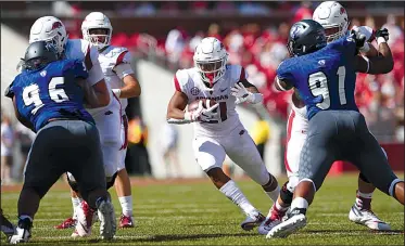  ?? NWA Democrat-Gazette/J.T. WAMPLER ?? Arkansas running back Devwah Whaley (center) looks for running room during Saturday’s victory over Eastern Illinois. Whaley led the Razorbacks’ struggling running game with 28 yards on 10 carries.