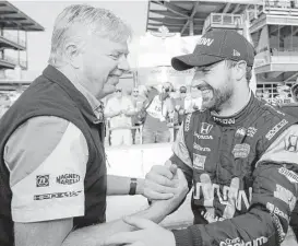  ?? Darron Cummings / Associated Press ?? James Hinchcliff­e, right, celebrates with a crew member after posting the top four-lap speed during the first day of qualifying for the Indianapol­is 500.