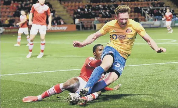  ?? ?? Crewe’s Kayne Ramsay brings down Sunderland’s Denver Hume.