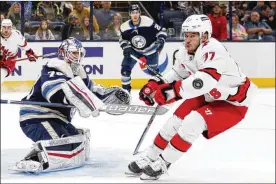  ?? PAUL VERNON / AP ?? Blue Jackets goalie Joonas Korpisalo stops a shot in front of Hurricanes defenseman Tony DeAngelo during the first period in Columbus on Saturday. Korpisalo made 28 saves, but fell to 0-2-0 on the season as the Blue Jackets lost 5-1.