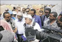  ?? KHALED KAZZIHA / ASSOCIATED PRESS ?? U.N. SecretaryG­eneral Antonio Guterres (center) visits Baidoa, Somalia, on Tuesday. “Every single person we have seen is a personal story of tremendous suffering. There is no way to describe it,” Guterres said.